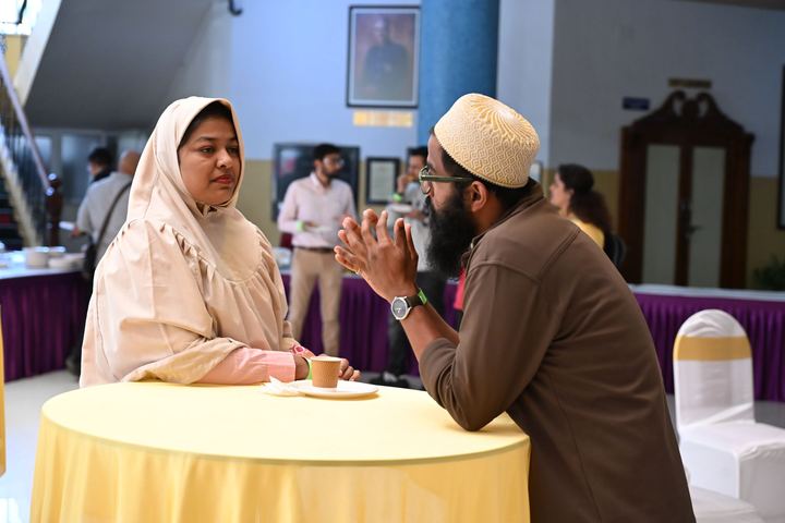 Two colleagues talking at a round table during an event